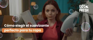 Persona eligiendo entre dos suavizantes de ropa frente a una lavadora